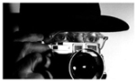 Henri Cartier-Bresson behind his rangefinder Leica